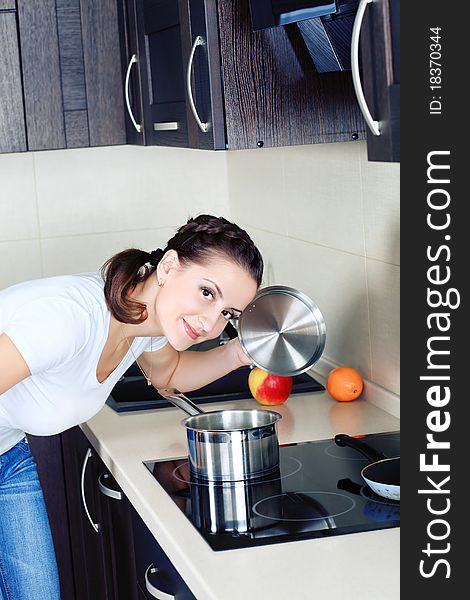 Woman is cooking on a kitchen at home.