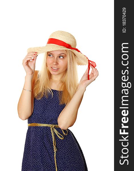 Beautiful young blond woman in a straw hat and a blue light summer dress.