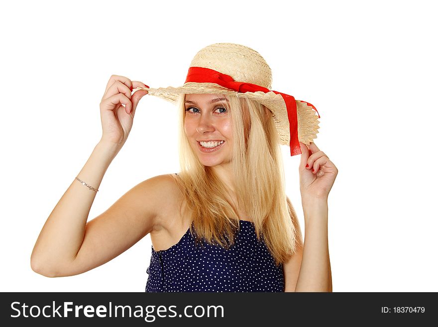 Beautiful young blond woman in a straw hat and a blue light summer dress.