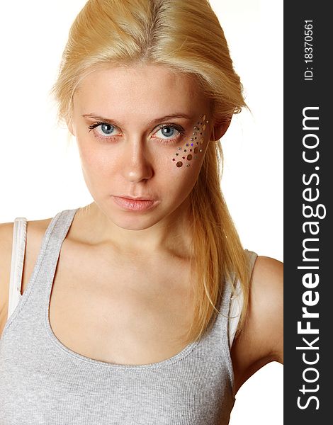 Beautiful young blond woman with makeup and multicolored crystals on the face. Beautiful young blond woman with makeup and multicolored crystals on the face