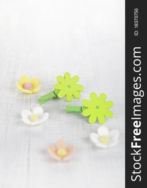 Decorative flower pegs with sugar flowers on white old table