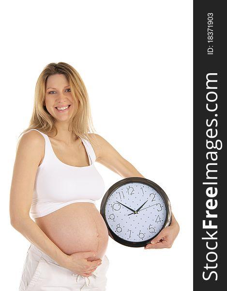 Happy pregnant woman with a round clock isolated on white