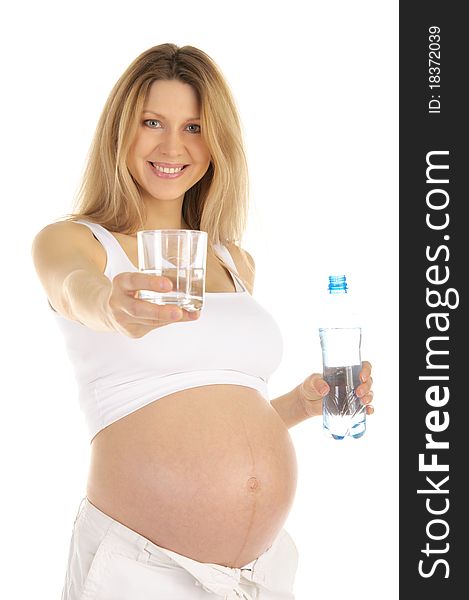 Pregnant woman holds out a glass of water isolated on white