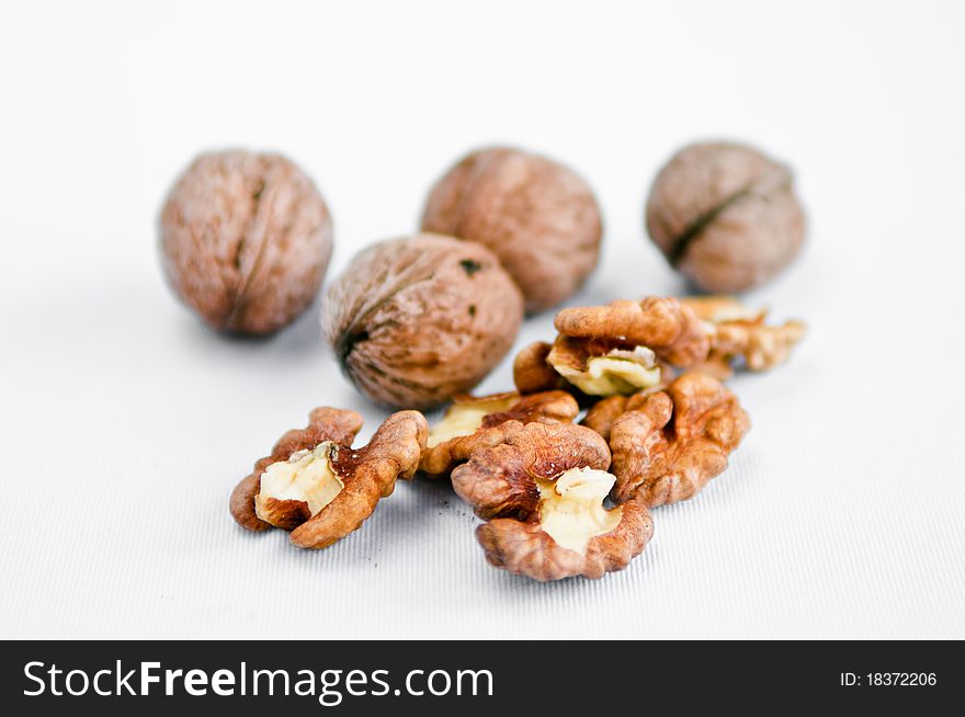 Ceil and clean walnuts on white table