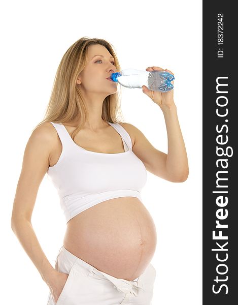 Pregnant woman drinks water from a bottle isolated on white