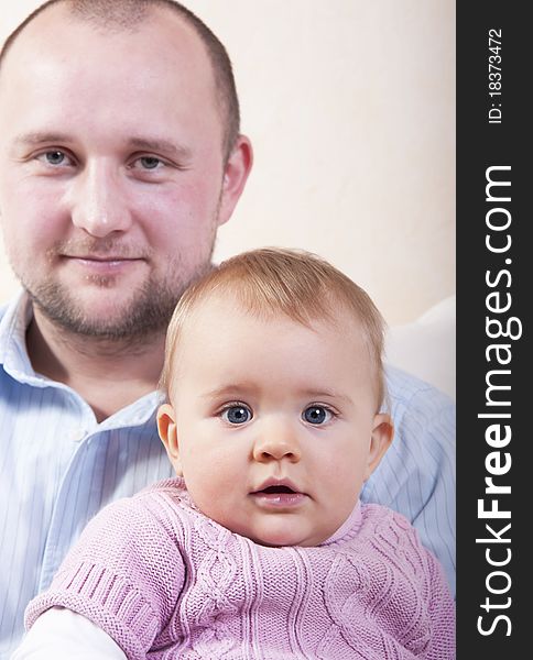 Sweet baby girl with her father in background. Sweet baby girl with her father in background