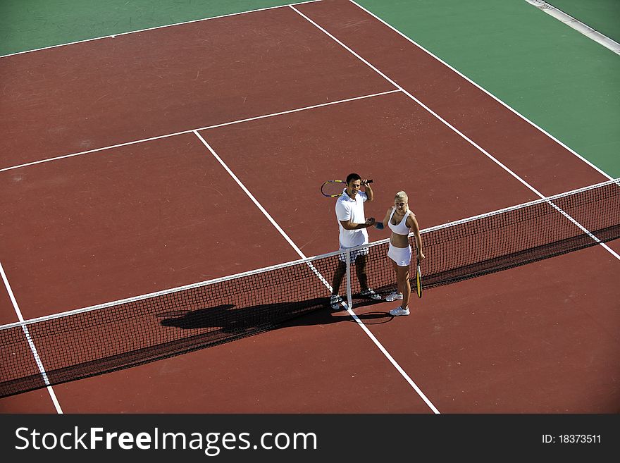 Happy young couple play tennis game outdoor men and women