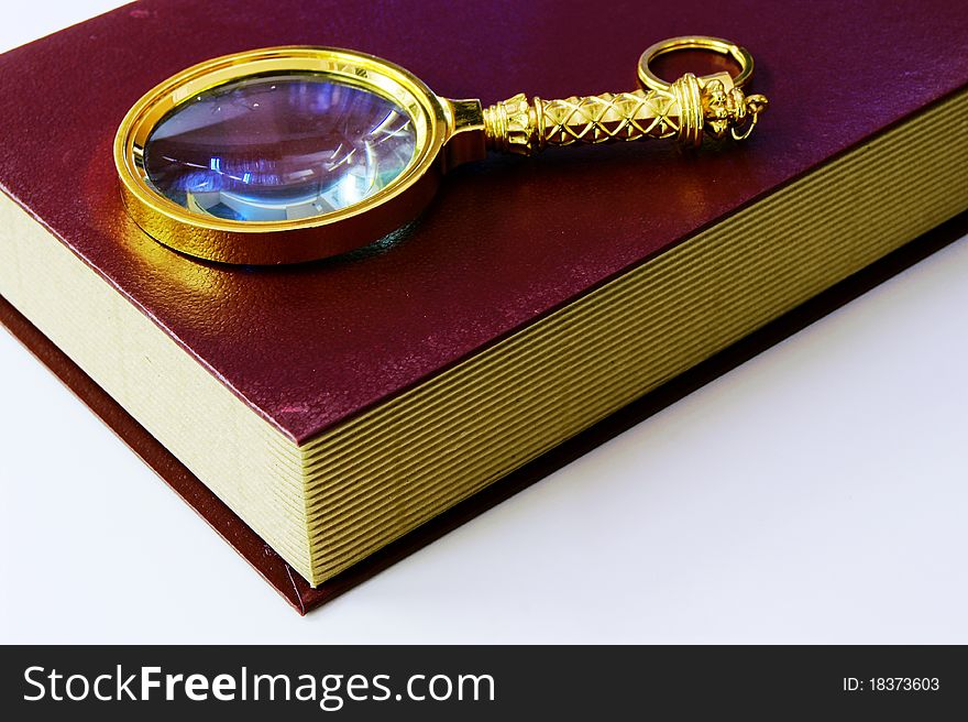 Book And Magnifying Glass