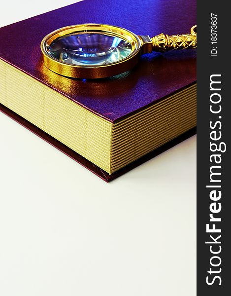 Book And Magnifying Glass