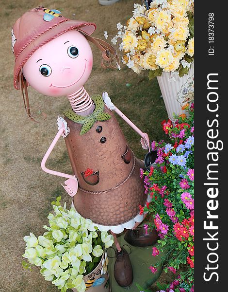 A tin gardener girl surrounding by flower