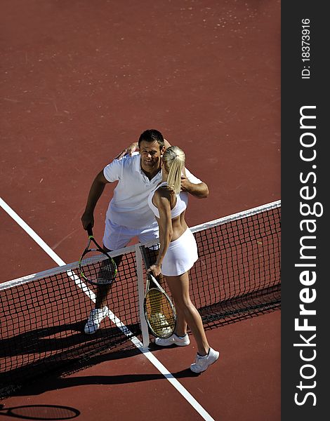 Happy young couple play tennis game outdoor man and women