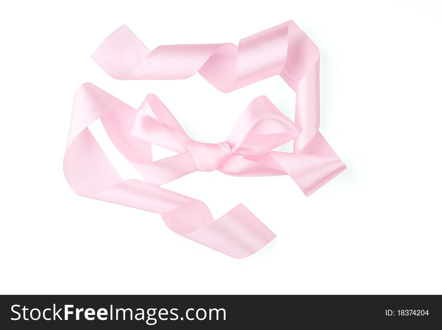 Bow of a pink ribbon on a white background. Bow of a pink ribbon on a white background.