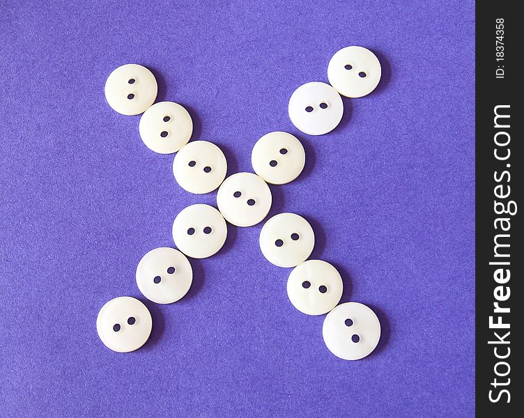 Figure cross icon from white buttons on purple background