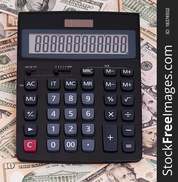 Calculator on money background of $5-$100 banknotes. Calculator on money background of $5-$100 banknotes