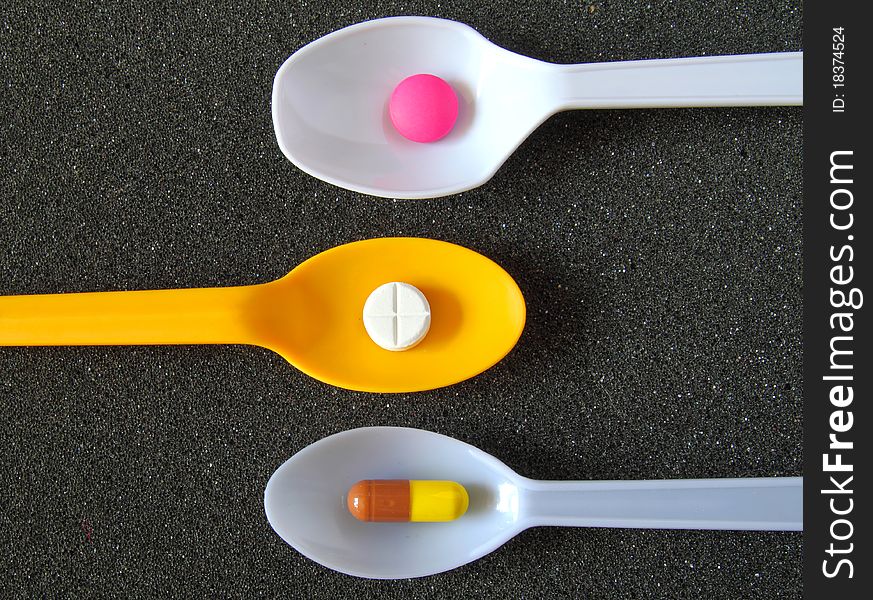 Spoonful of Pills on black textile