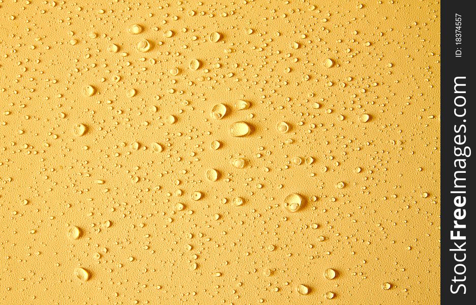 Beautiful drops of water on yellow background