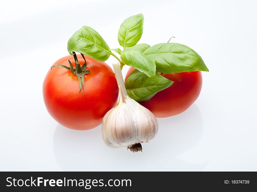 Tomato, mint and garlic on a light background. Symbols of Mediterranean cuisine