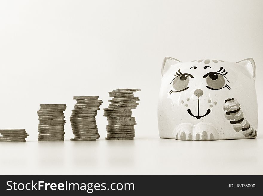 Coins and money bank on a white background