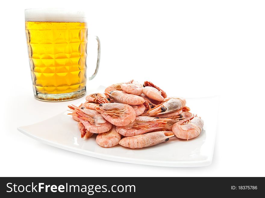 Fresh, cold beer in glass and fried shrimps on plate. Isolated on white. Fresh, cold beer in glass and fried shrimps on plate. Isolated on white
