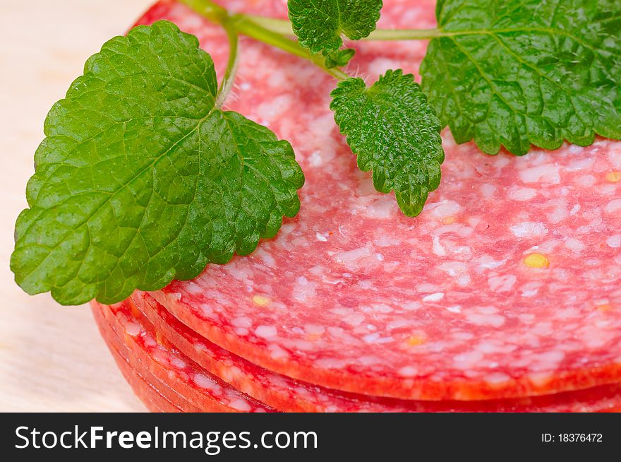 Salami as a close-up with herbs.