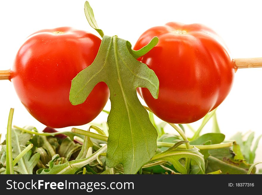 Small cherry tomatoes closeup on white background