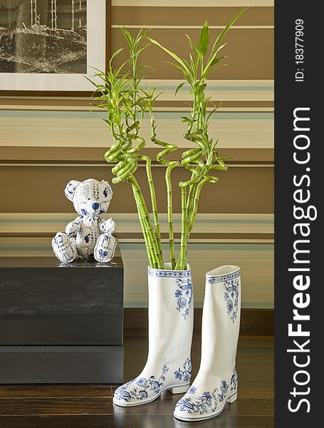 gumboots and teddy bear in interior