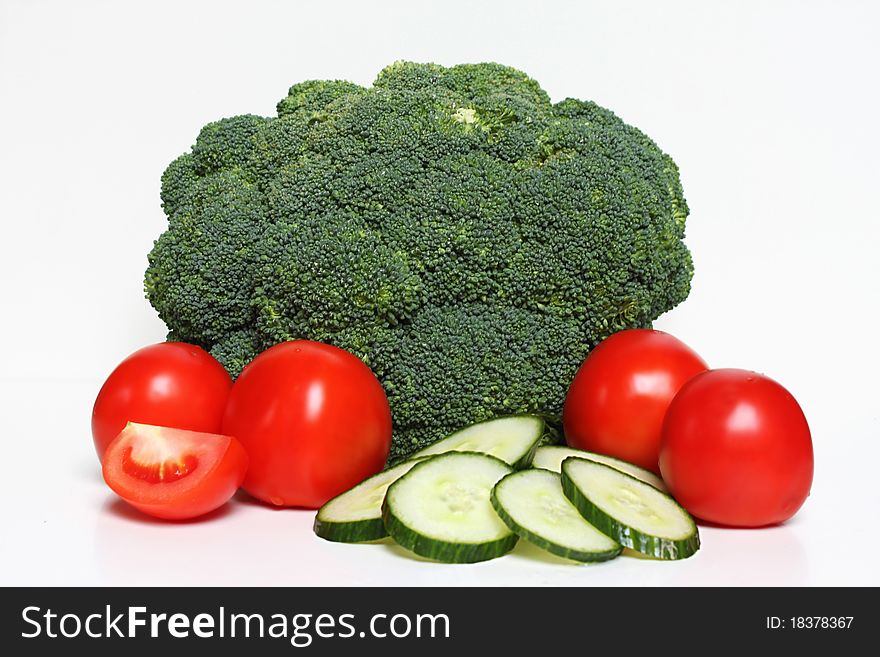 Fresh broccoli, cucumber and tomato on a white background. Fresh broccoli, cucumber and tomato on a white background