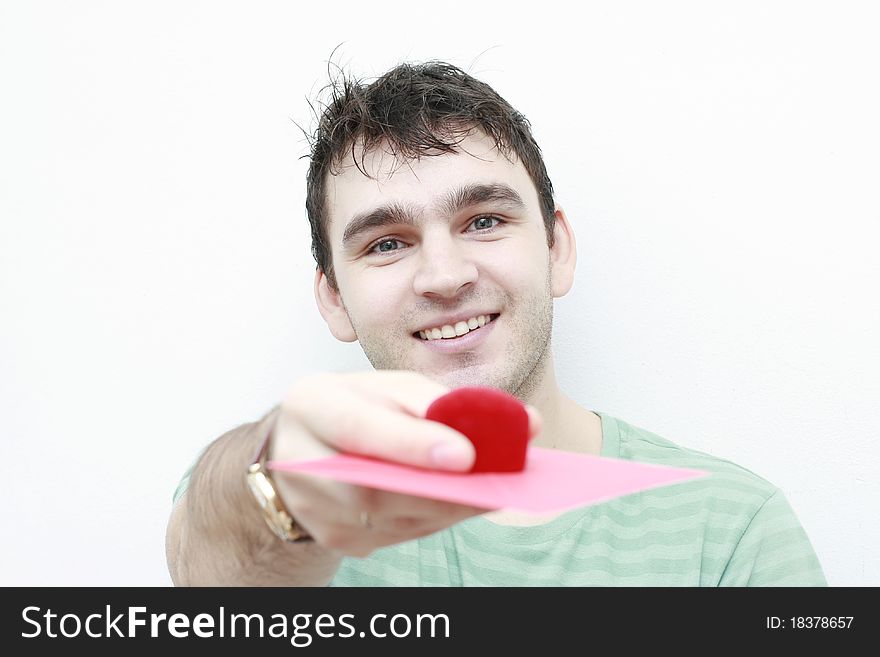 Young man with envelope and red little box in his right hand showing them to the camera. Young man with envelope and red little box in his right hand showing them to the camera