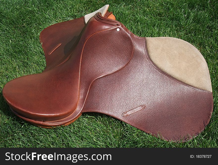 New English leather horse saddle made in Argentina taken from the side. New English leather horse saddle made in Argentina taken from the side
