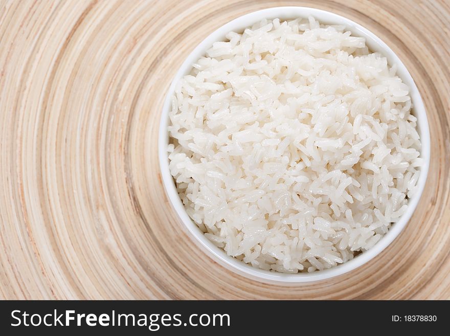 Rice in a bowl on a bamboo plate