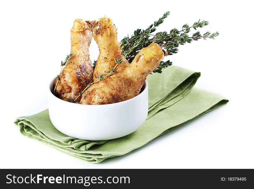 Roasted chicken legs with thyme in a bowl