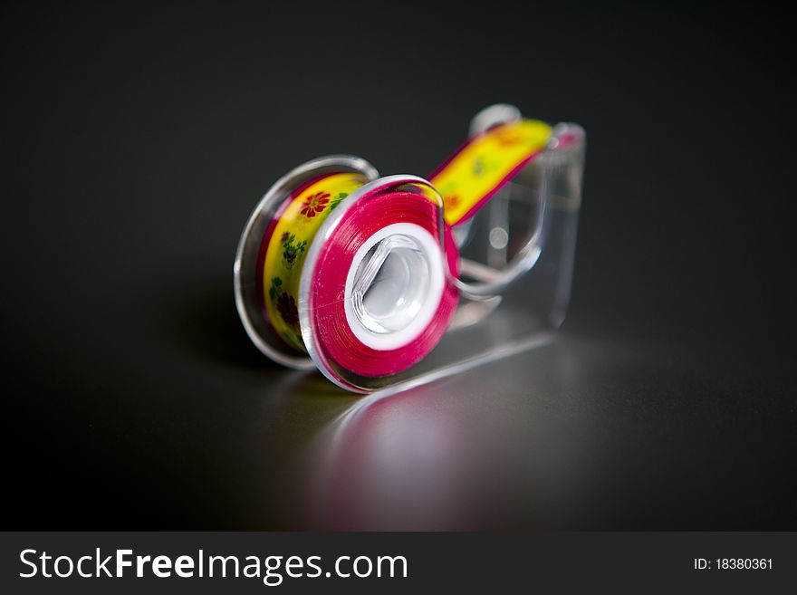 This is a tape dispenser with colored tape