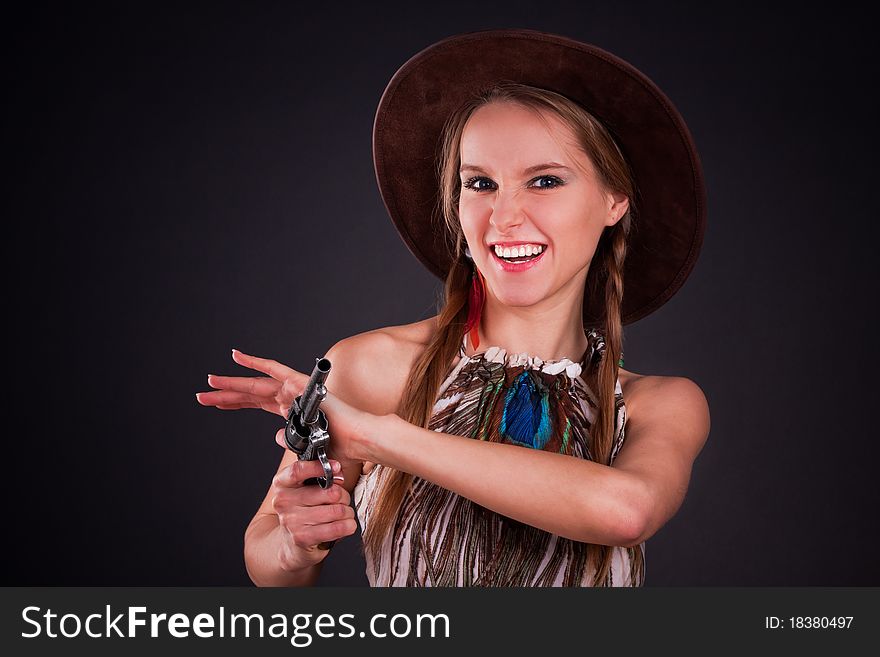 The American Indian girl in a cowboy's hat holds a pistol