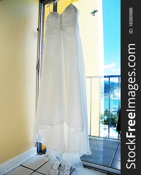 Dress hanging in tropical resort window. Dress hanging in tropical resort window