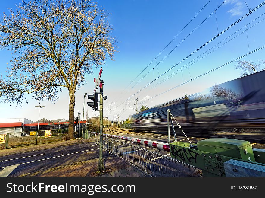 A freight train passing a level crossing. A freight train passing a level crossing