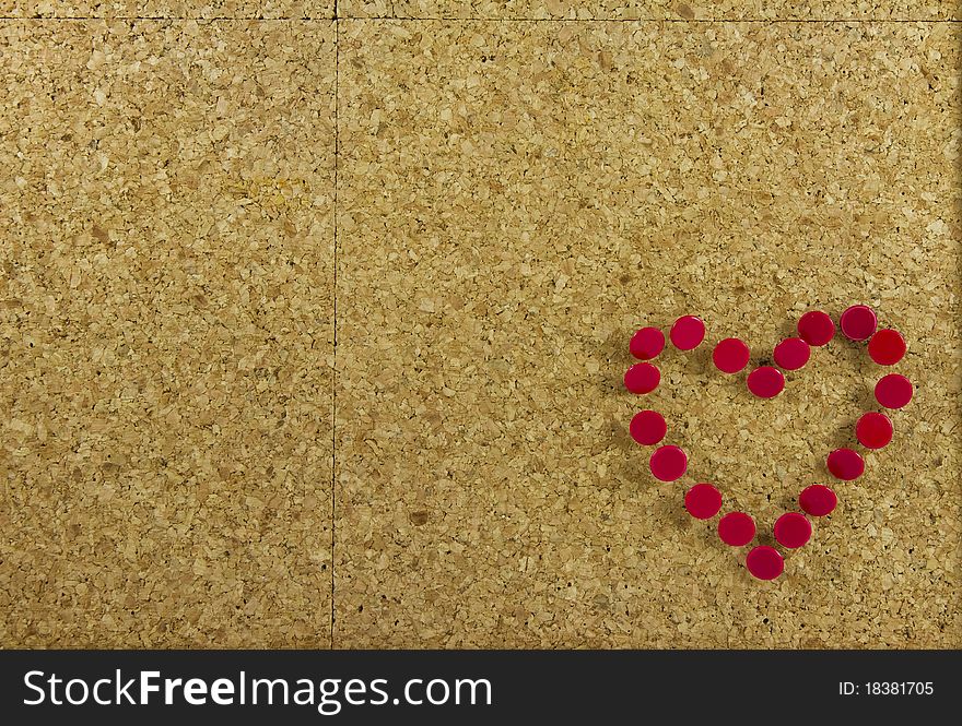 Corkboard background with red heart