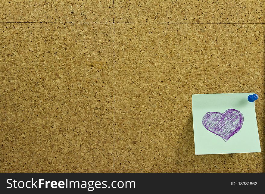Corkboard background with blue sticker note and purple heart