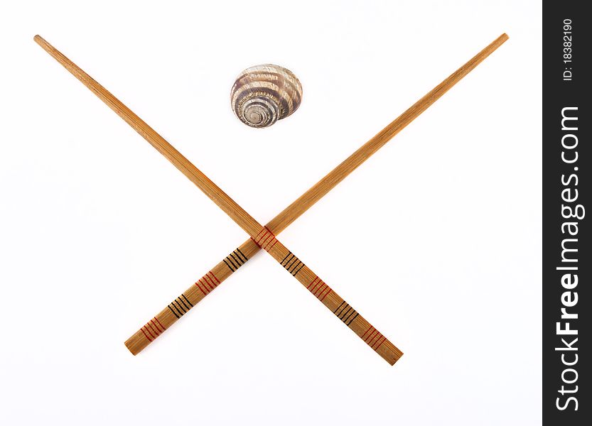 Chopsticks and snail isolated on white background