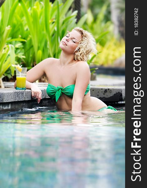 Young beautiful womam relaxing in pool. Young beautiful womam relaxing in pool