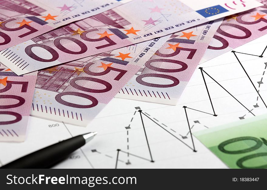 Close-up of euro banknotes, graphs and pen. Close-up of euro banknotes, graphs and pen