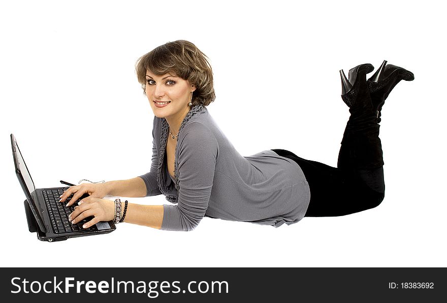 Smiling Pretty Woman Laying on the Floor and Using a Laptop. Smiling Pretty Woman Laying on the Floor and Using a Laptop