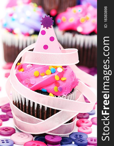 Mini cupcake with b-day hat decoration, buttons and ribbon. Mini cupcake with b-day hat decoration, buttons and ribbon