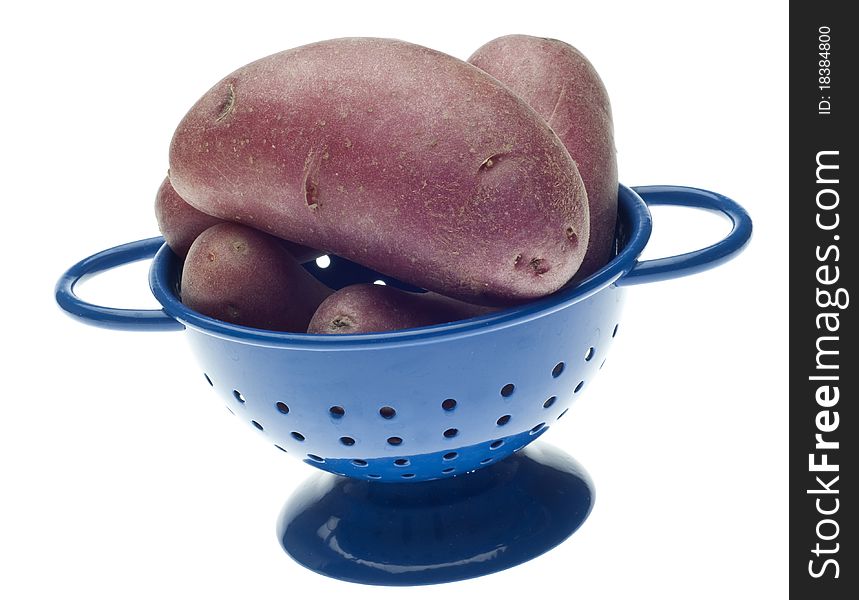Whole Baby Red Potato in Blue Colander Isolated on White with a Clipping Path.