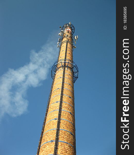 Old brick chimney in the blue sky