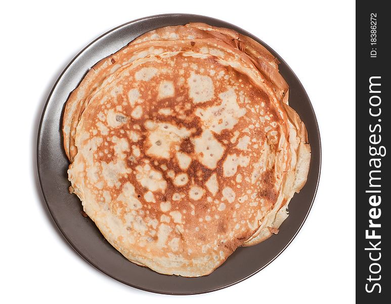 Fresh pancakes on a brown plate on the white background