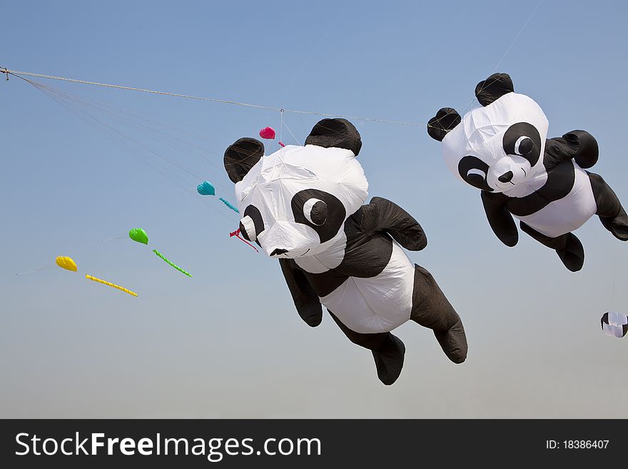 Creative kites, panda-shaped, on blue sky. Creative kites, panda-shaped, on blue sky