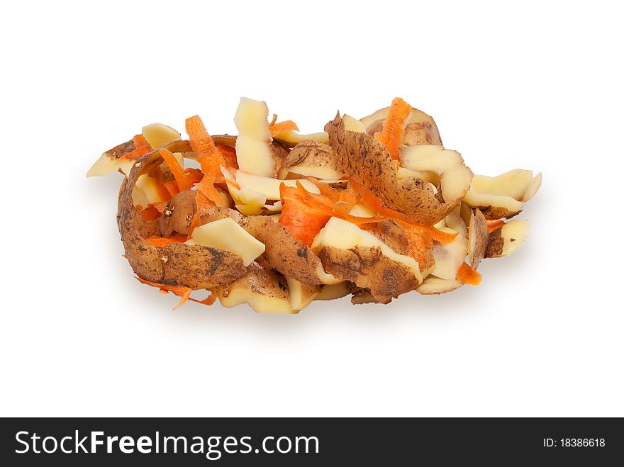 The cleared peel of a potato and carrots on a white background