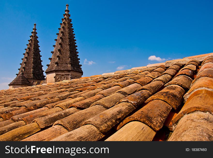 Old church roof with pointy little towers, blue sky and white cloud. Old church roof with pointy little towers, blue sky and white cloud