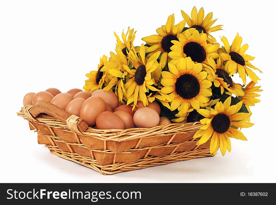 Eggs and sunflowers on a white background. Eggs and sunflowers on a white background.