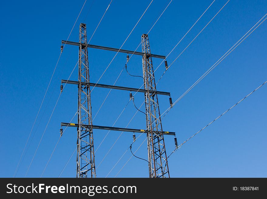 Power wire pylon against clear blue sky. Power wire pylon against clear blue sky.